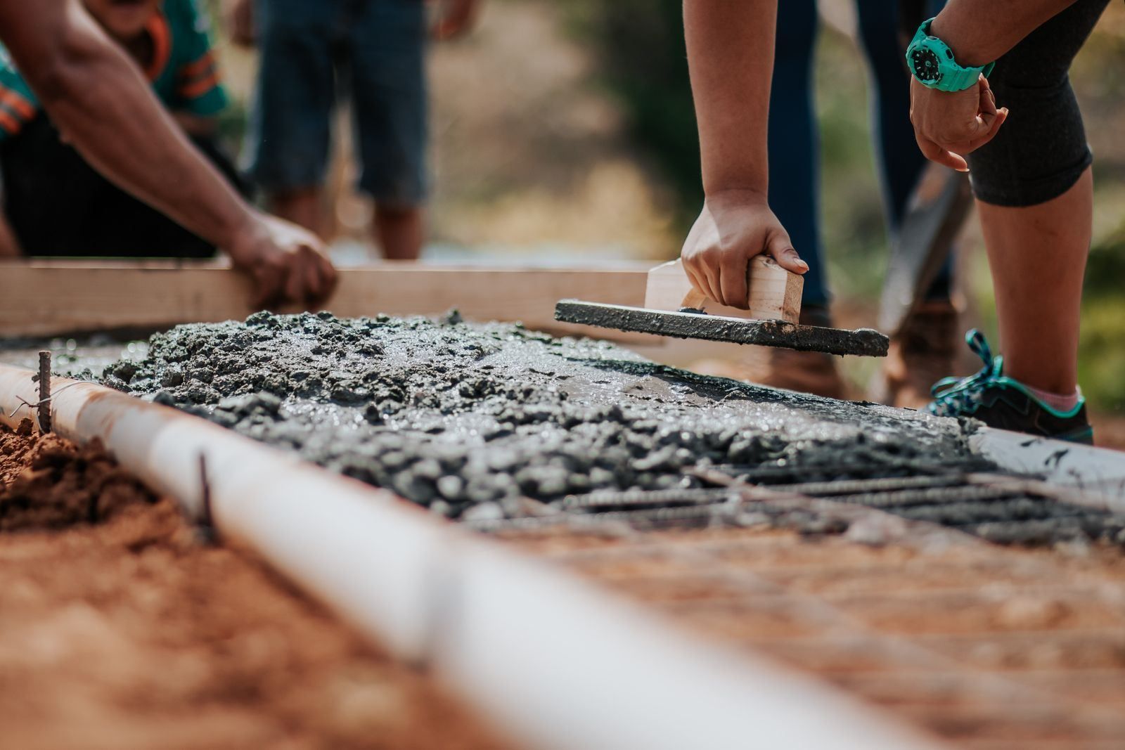 Construction crew finishing concrete on a jobsite